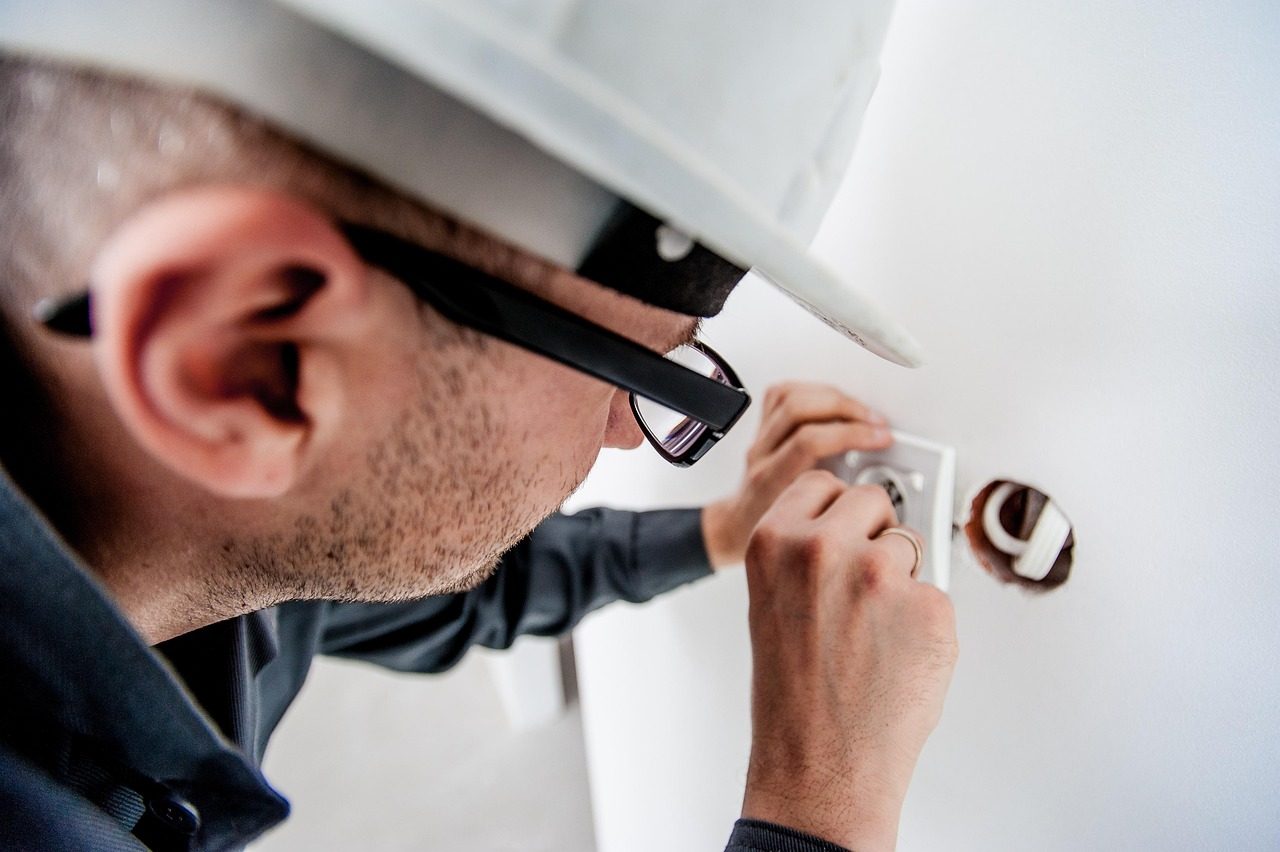 An electrician installing an electrical outlet