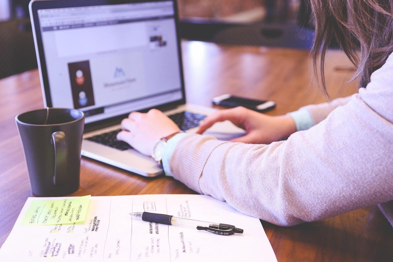 A small-business owner working on their website at a laptop